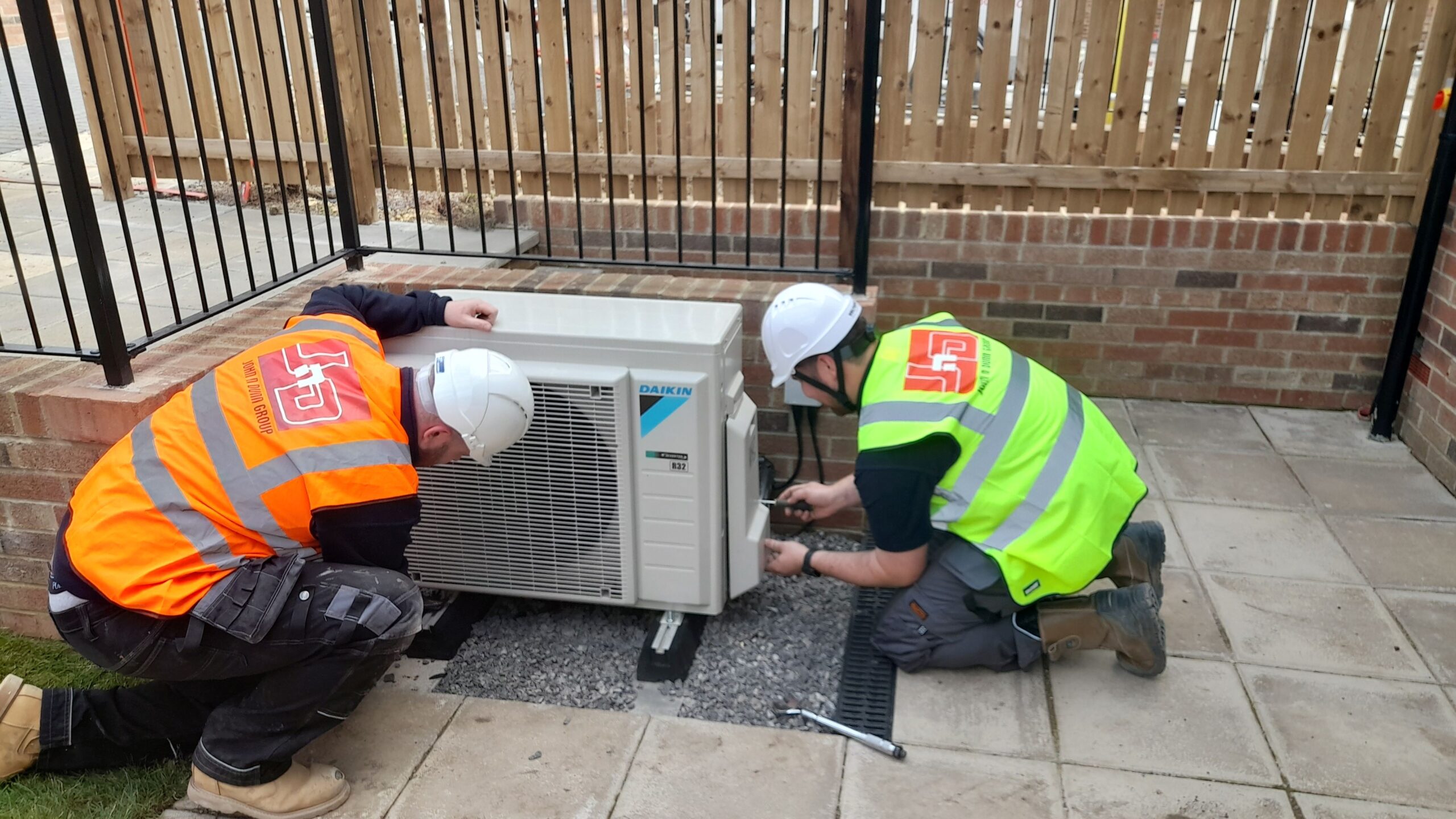 Members of the John N Dunn Group team working on an air source heat pump installation