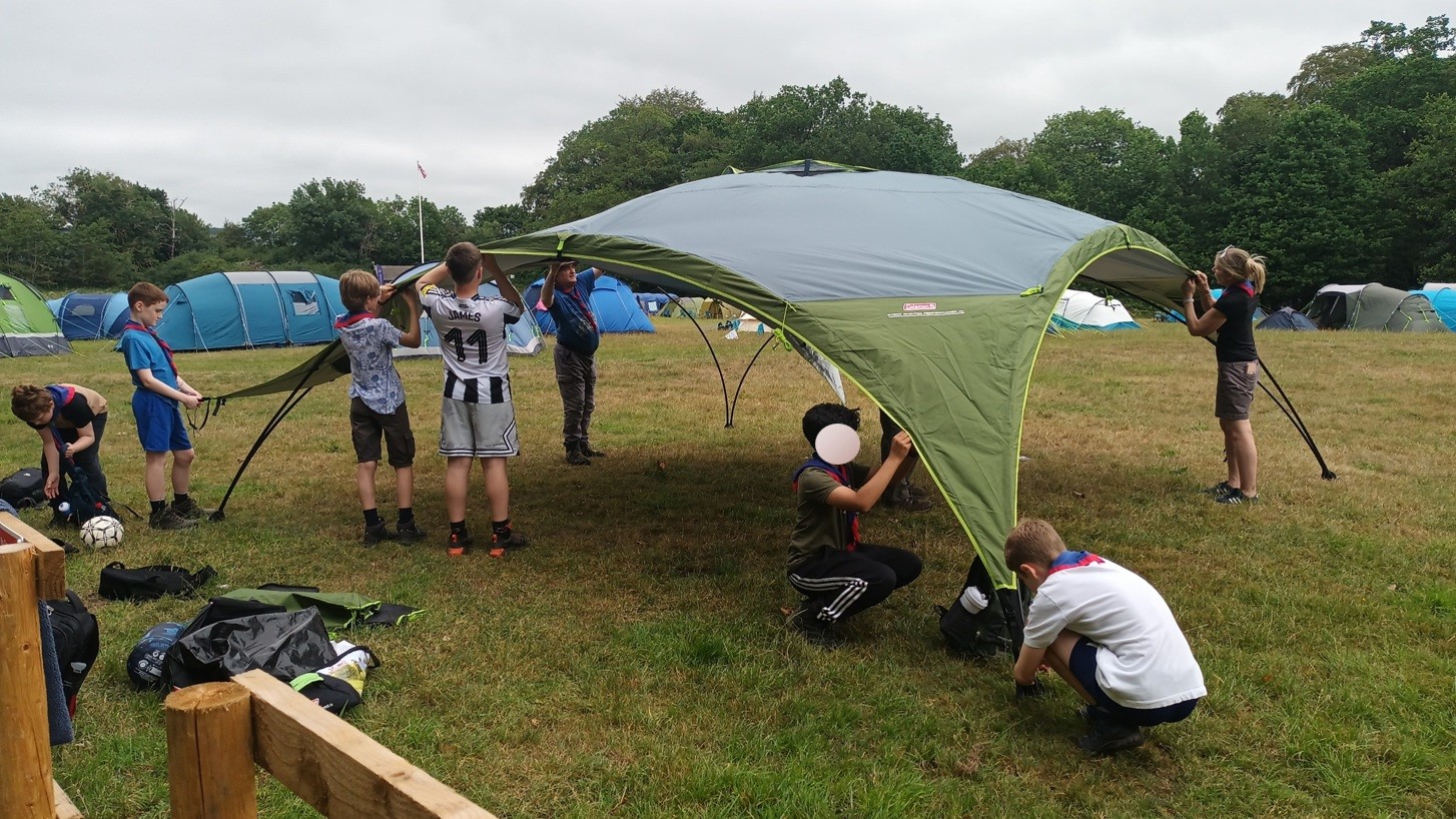 Members of the 1st Killingworth Scouts putting up one of their new event shelters